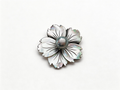 Flower-shaped brooch featuring a Tahitian Silver Gray Pearl.